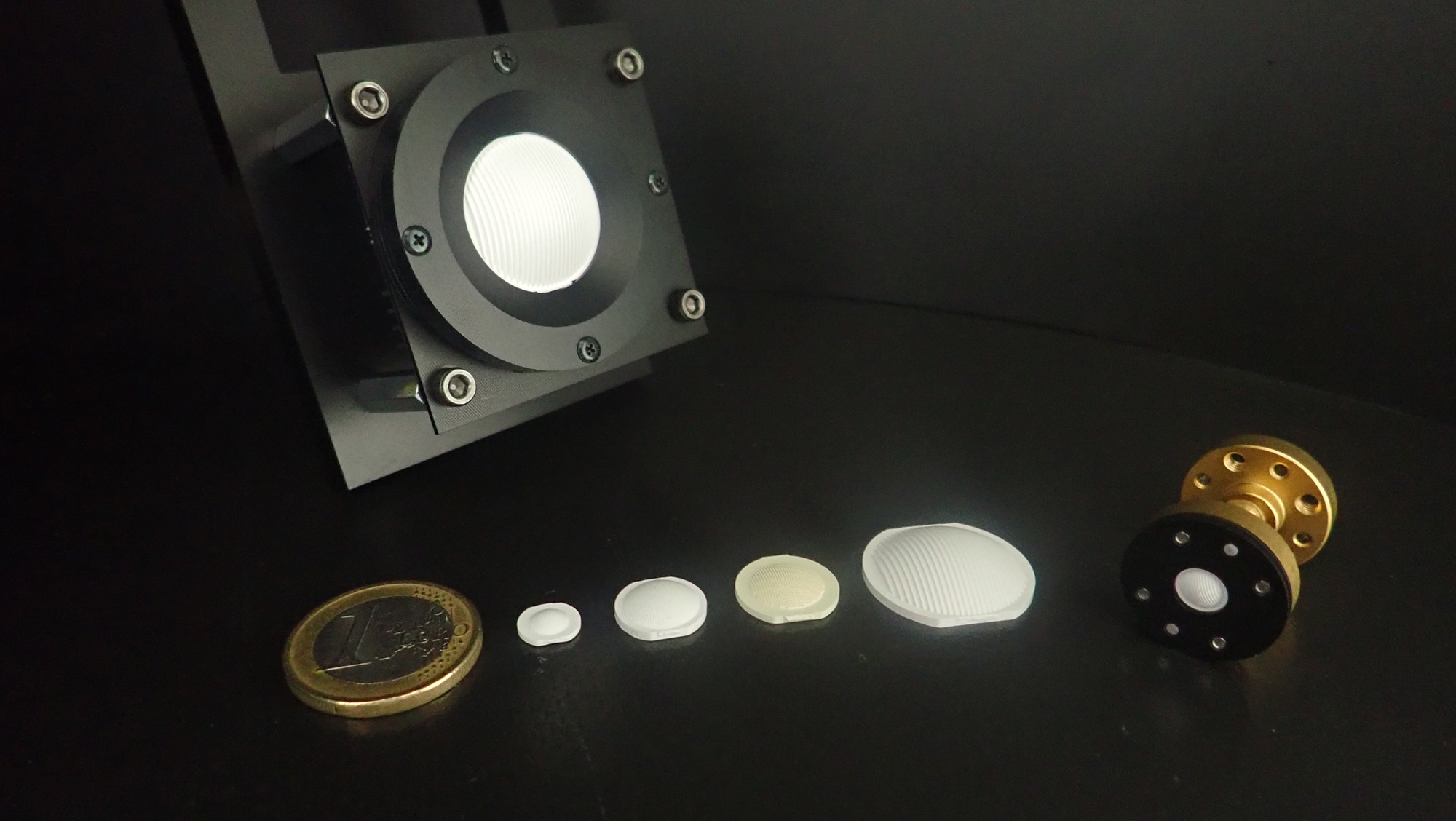 Injection Molded Lens Antenna compared to a one euro coin